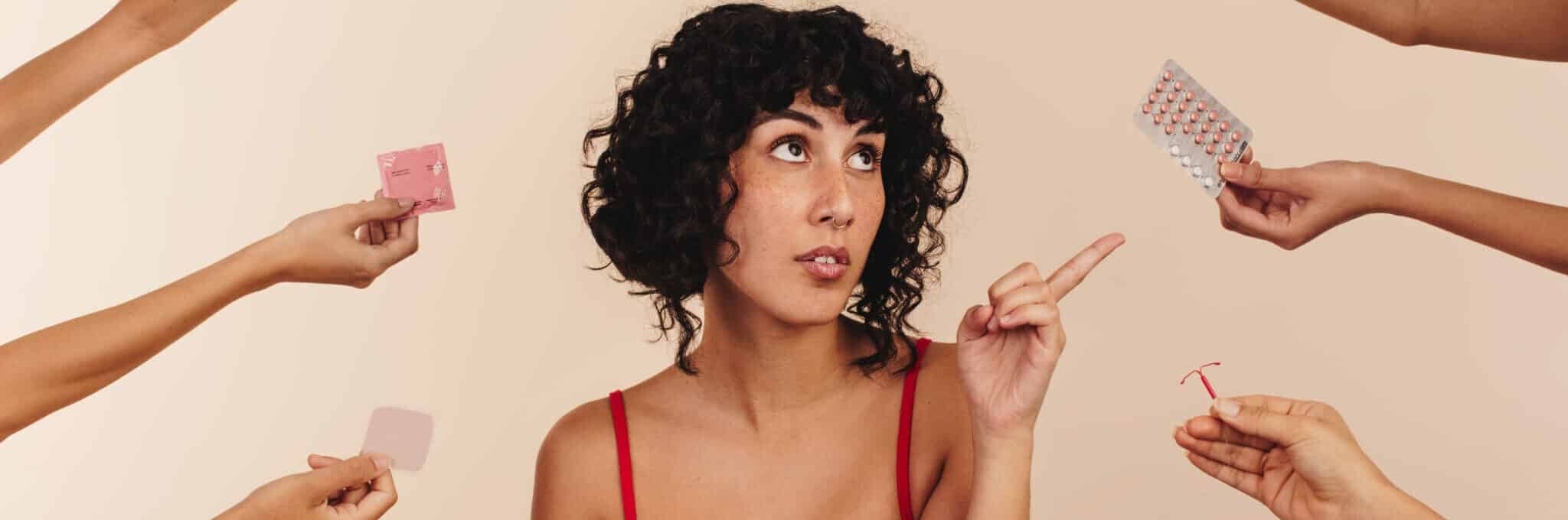 Kvinde vælger mellem forskellige præventionsmidler som p-piller, spiral og plaster.
